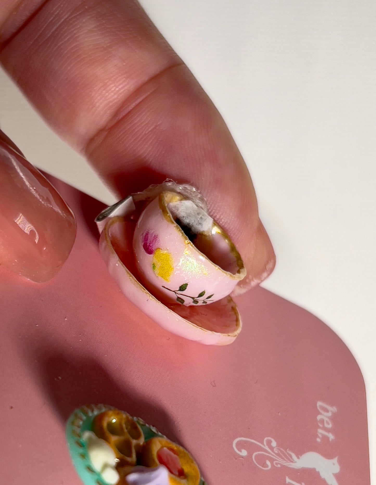 009 - Mini pink teacup with tea bag, cookies on teal saucer