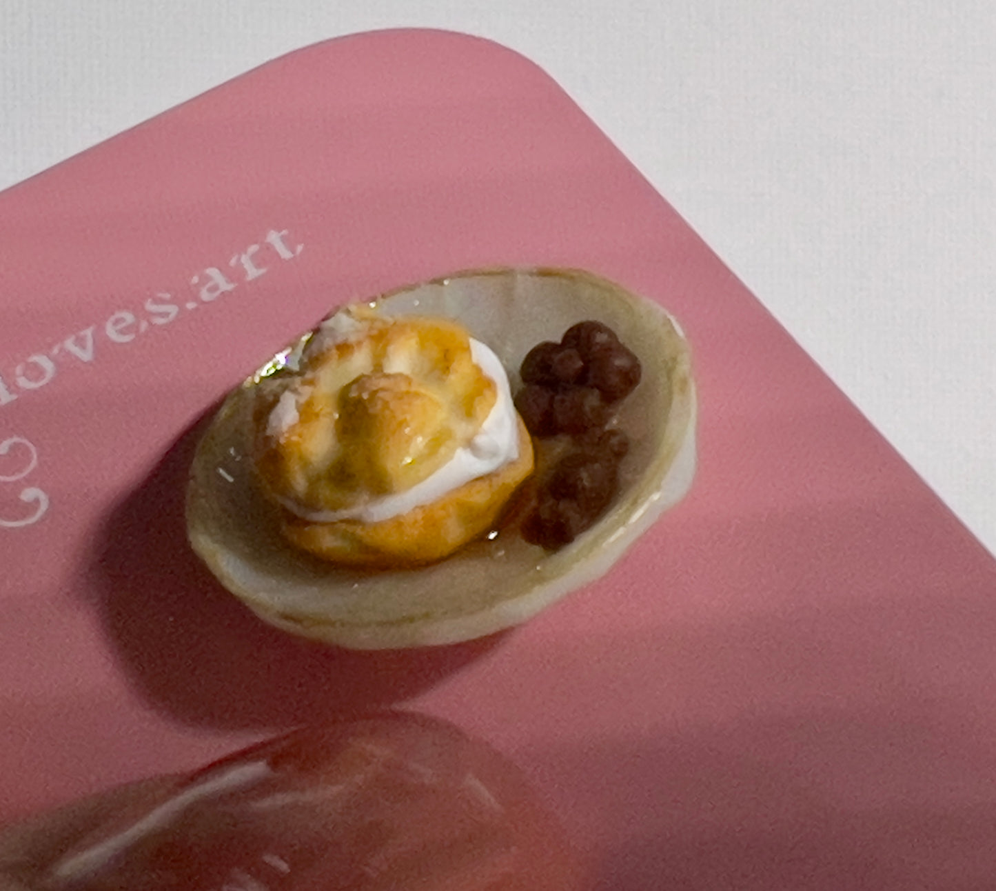 003 - Mini yellow teacup with tea bag, cream puff and chocolates on white saucer
