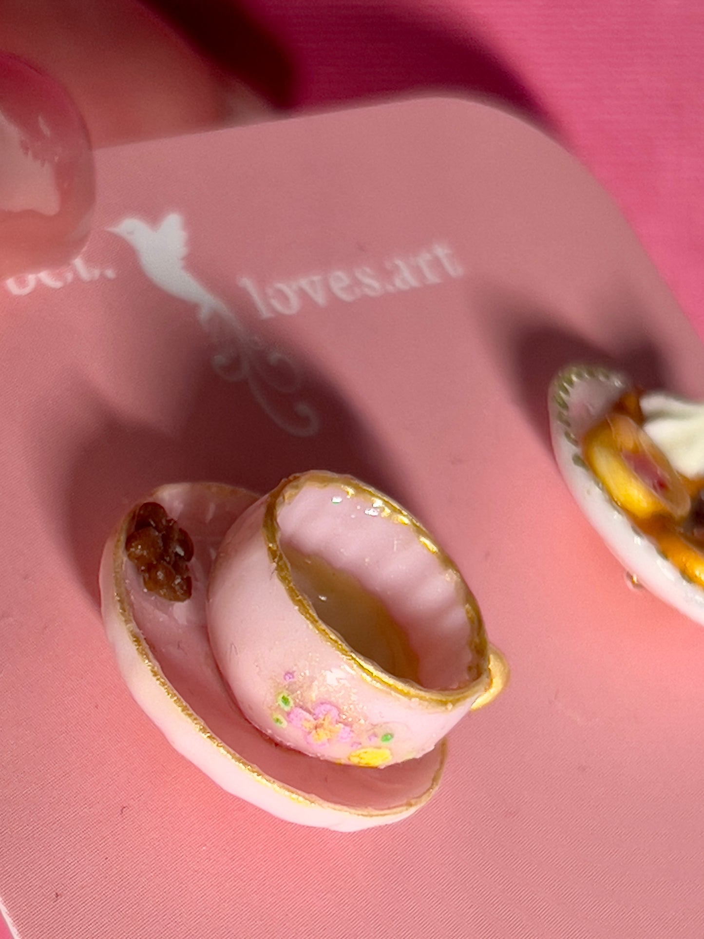 022 - Mini pink teacup and a white saucer of cookies