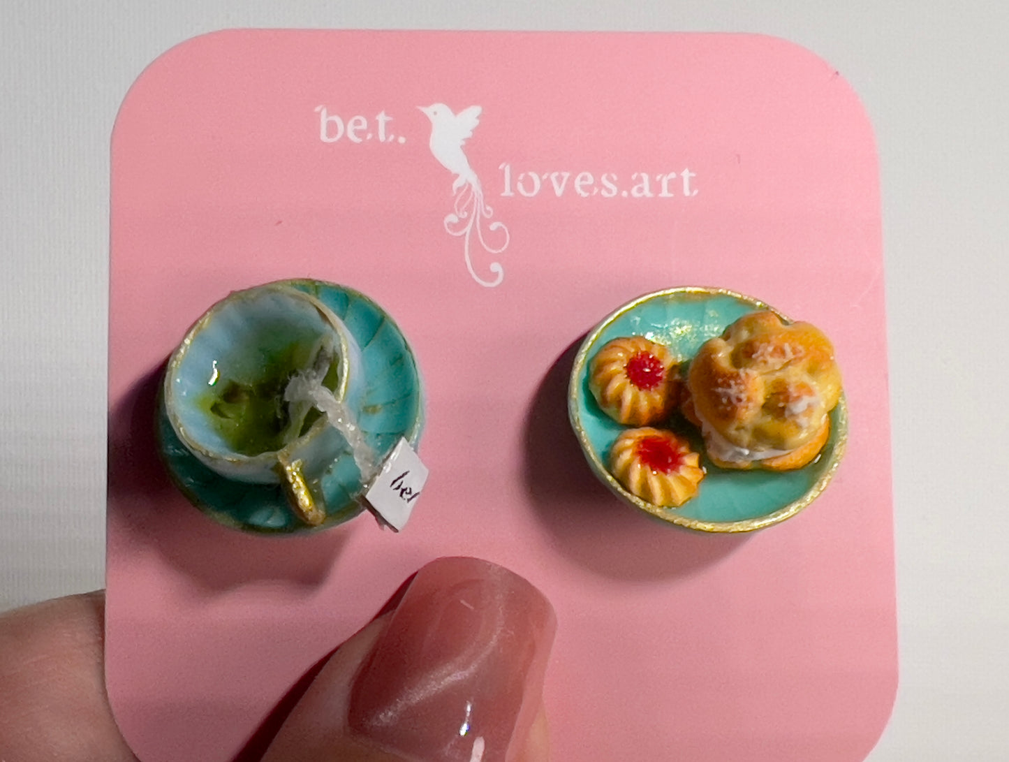 002 - Mini teal teacup with tea bag, teal saucer with cream puff and two cookies