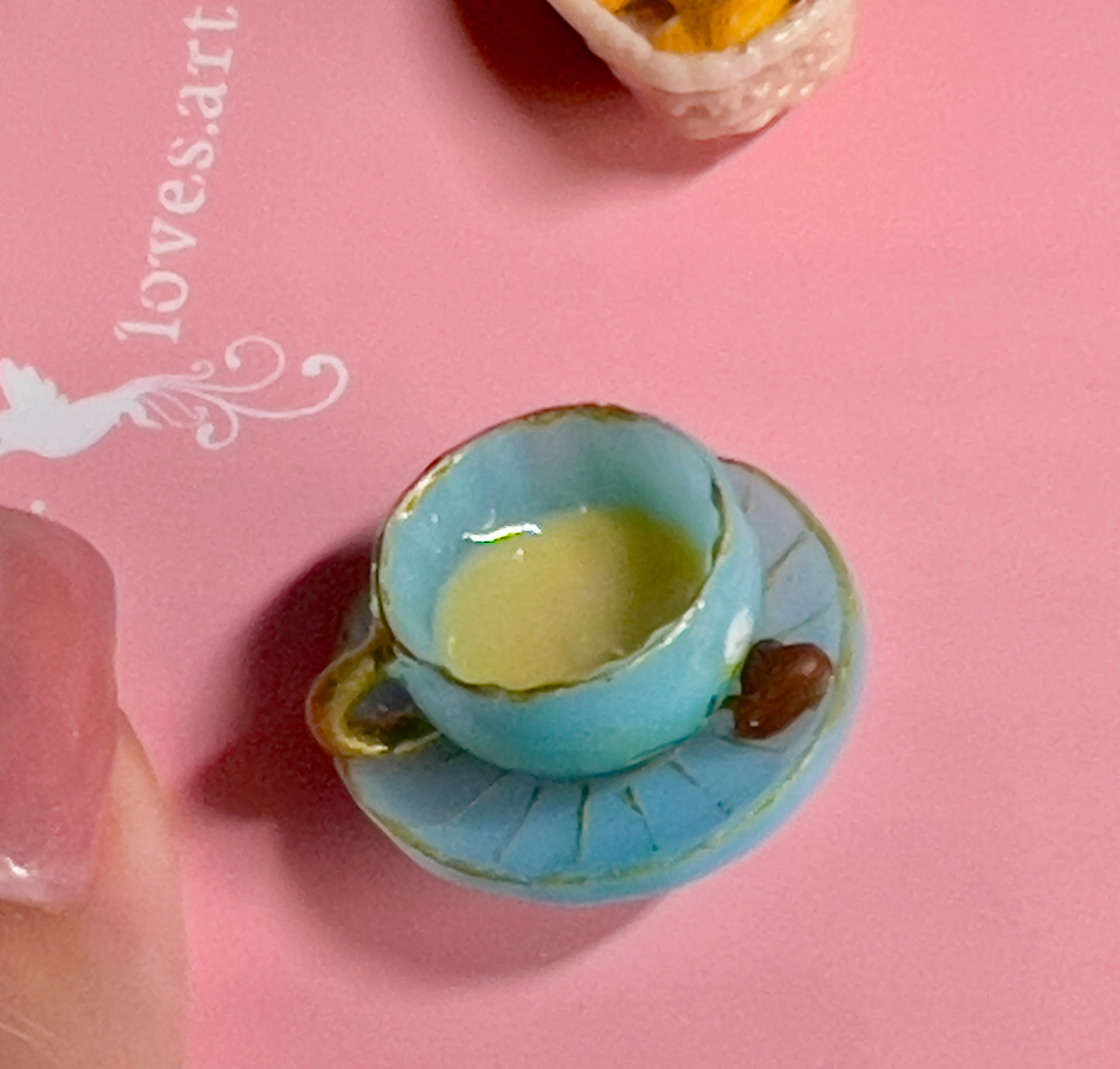020 - Mini blue teacup and a basket of croissant