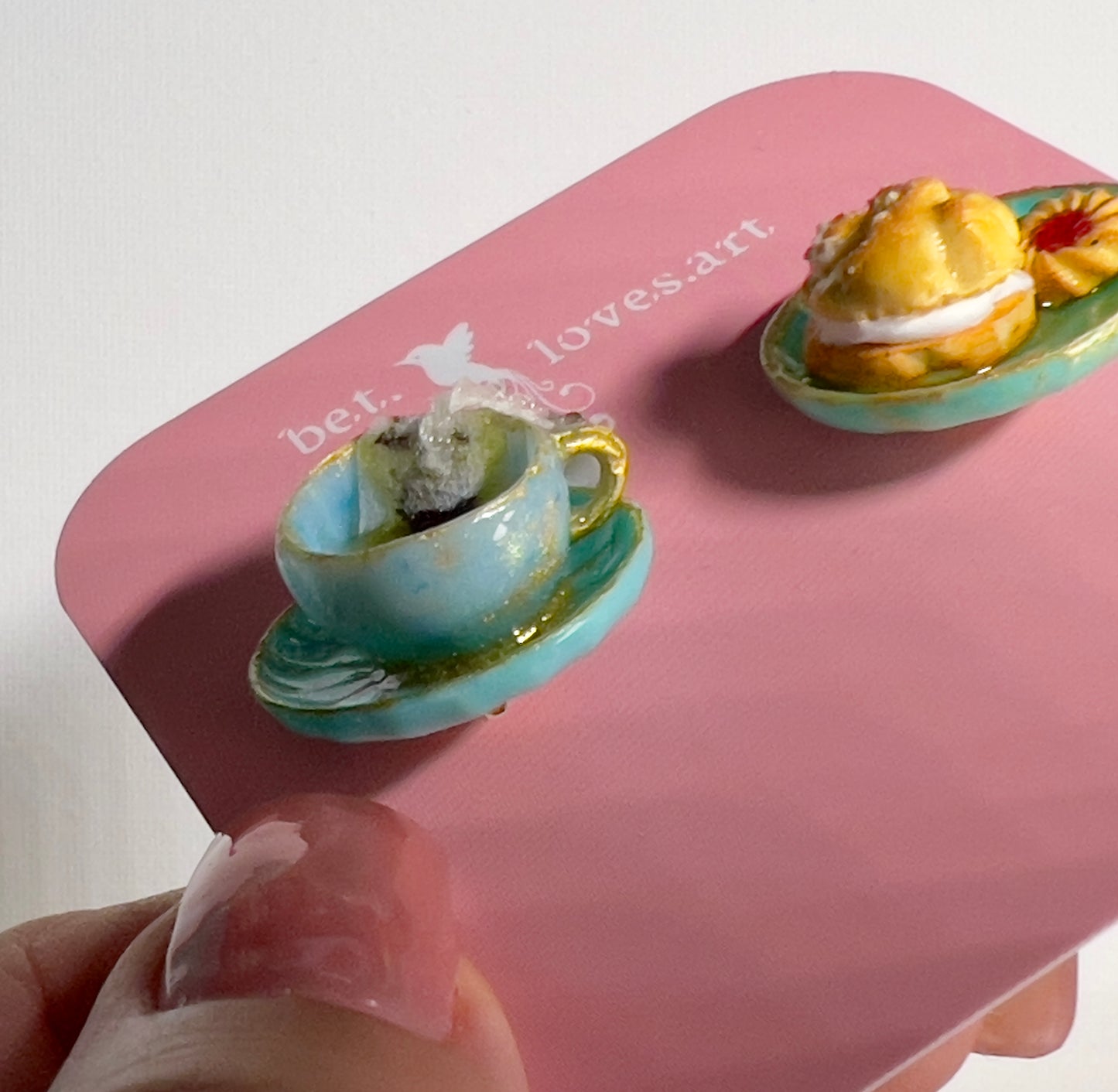002 - Mini teal teacup with tea bag, teal saucer with cream puff and two cookies