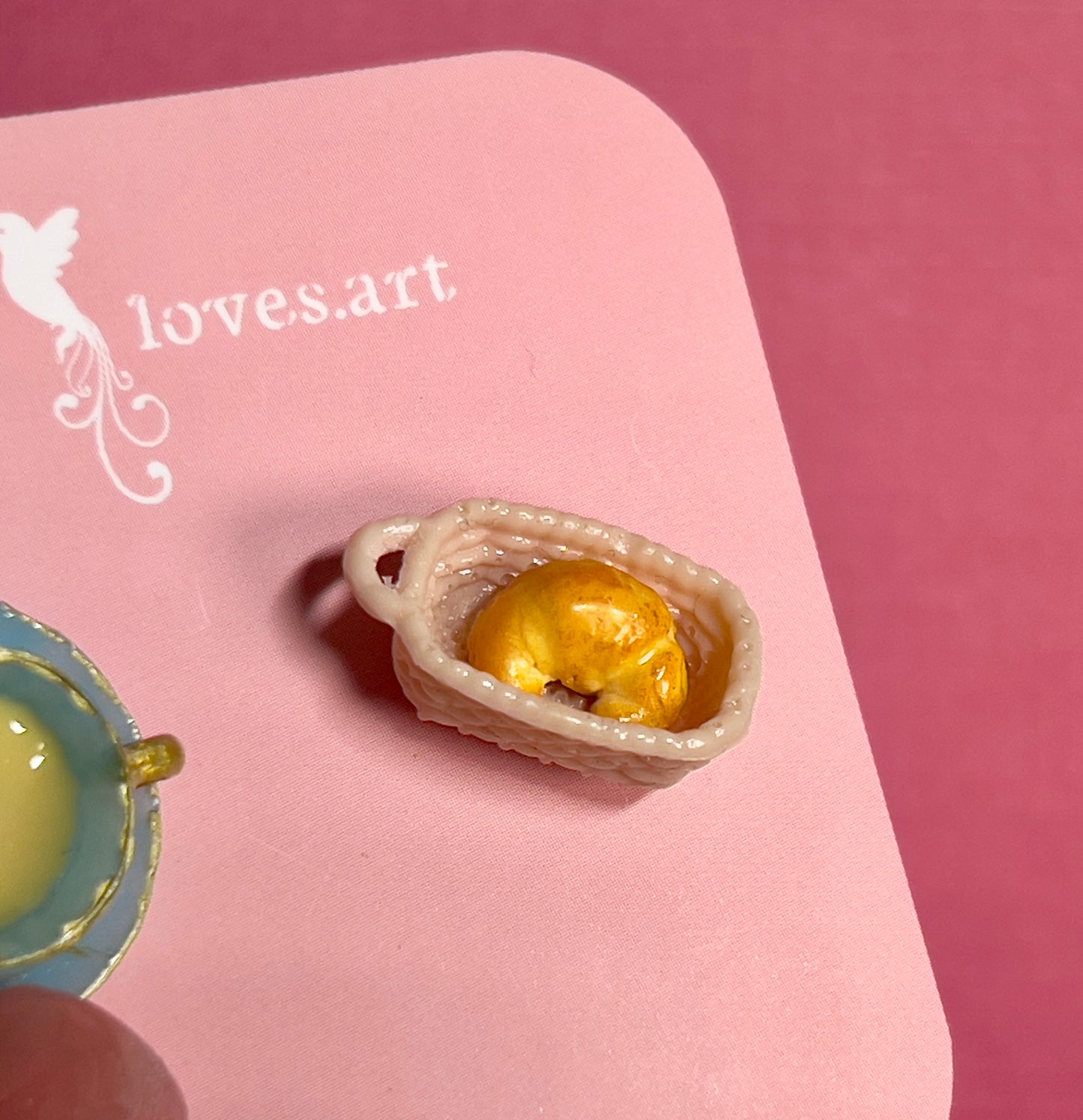 020 - Mini blue teacup and a basket of croissant