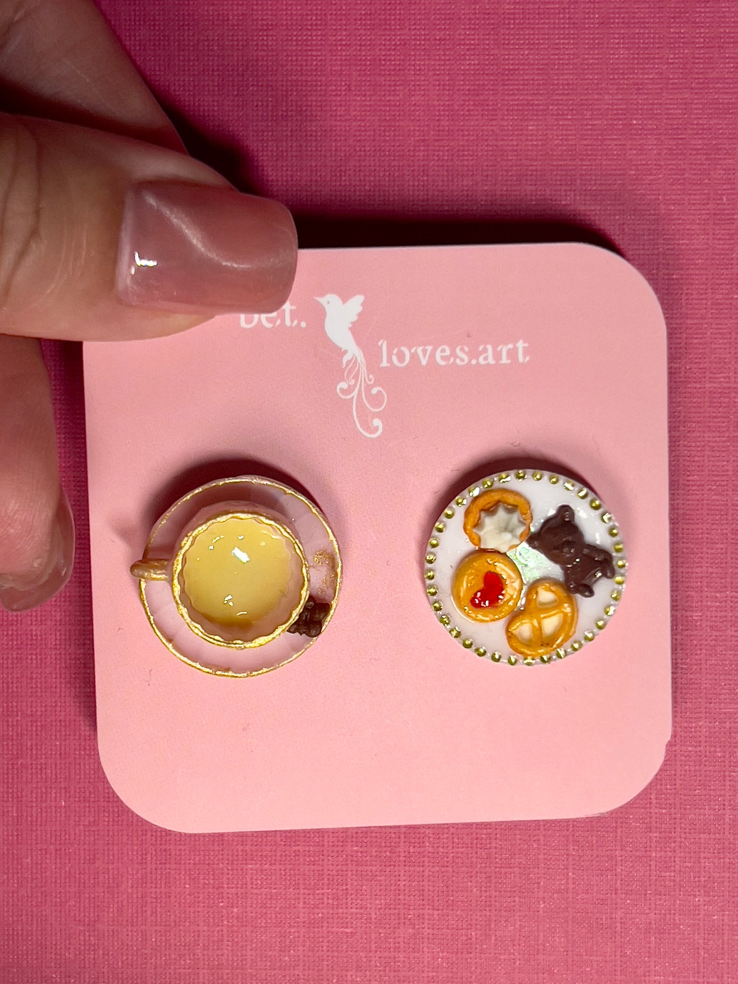 022 - Mini pink teacup and a white saucer of cookies