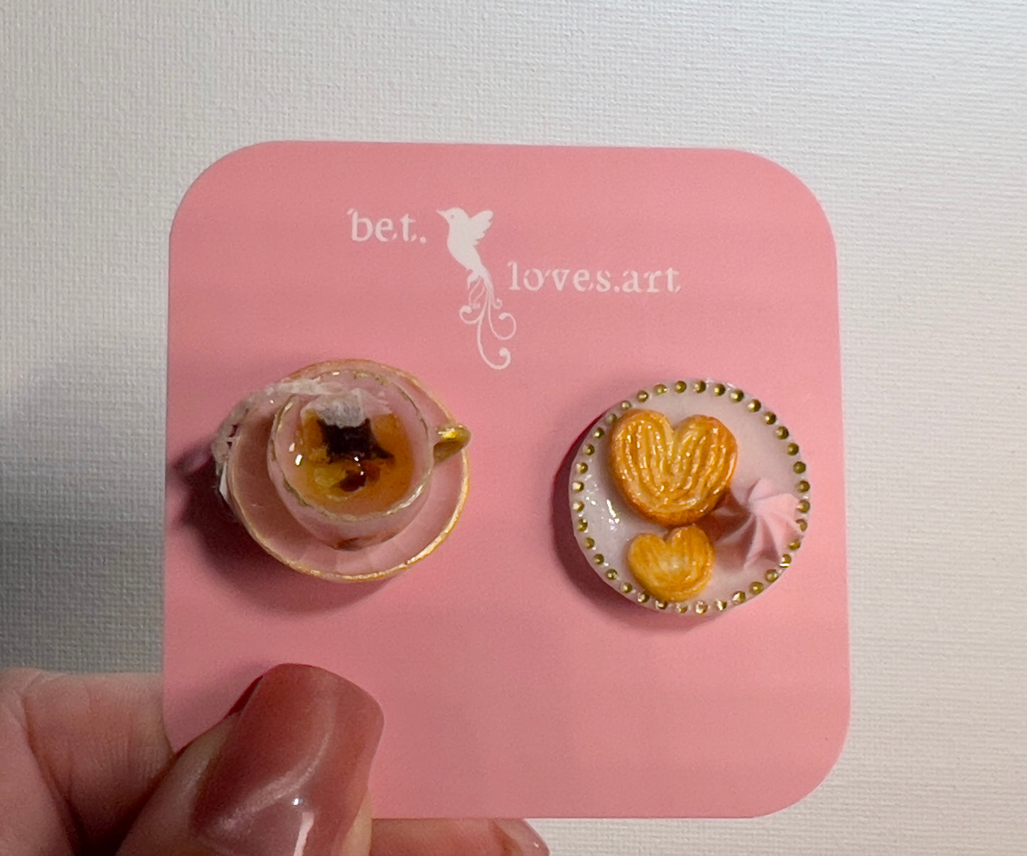 004 - Mini pink teacup with tea bag, palmiers and meringue on white saucer