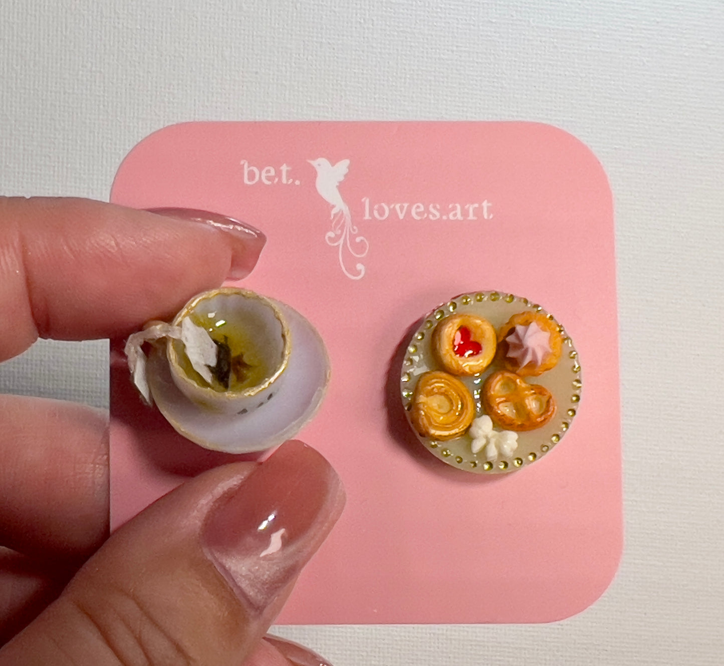 006 - Mini white teacup with tea bag, cookies on yellow saucer