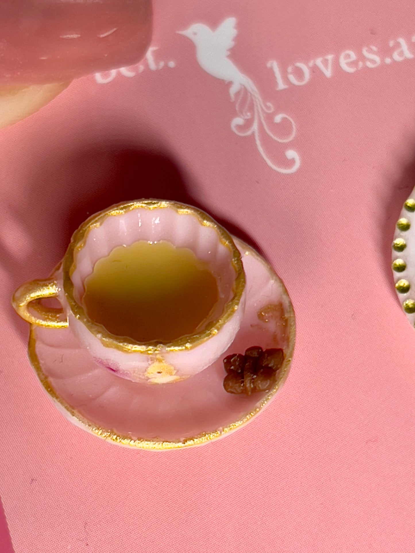 022 - Mini pink teacup and a white saucer of cookies