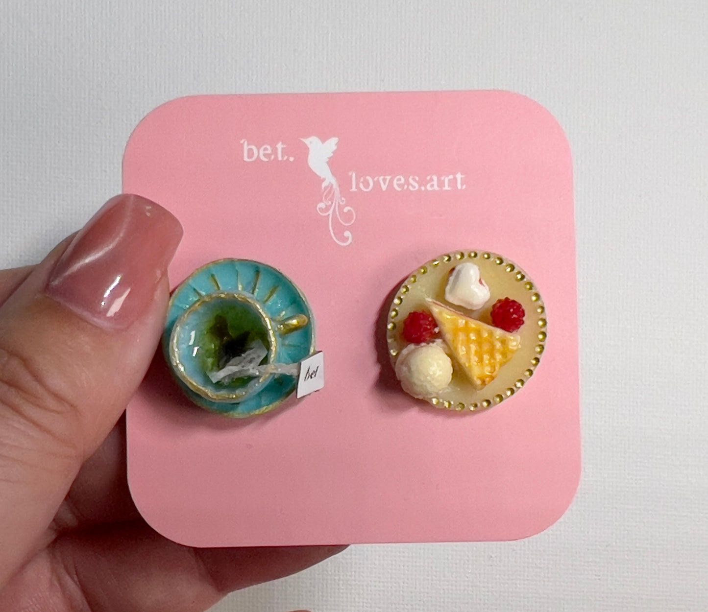 010 - Mini teal teacup with tea bag, waffle, raspberries, macaroon and vanilla ice cream on yellow saucer