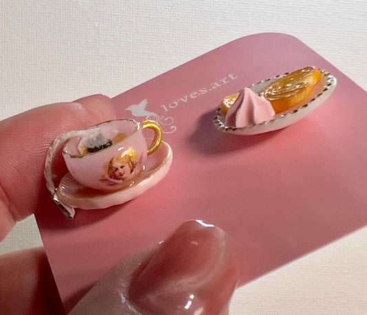 004 - Mini pink teacup with tea bag, palmiers and meringue on white saucer