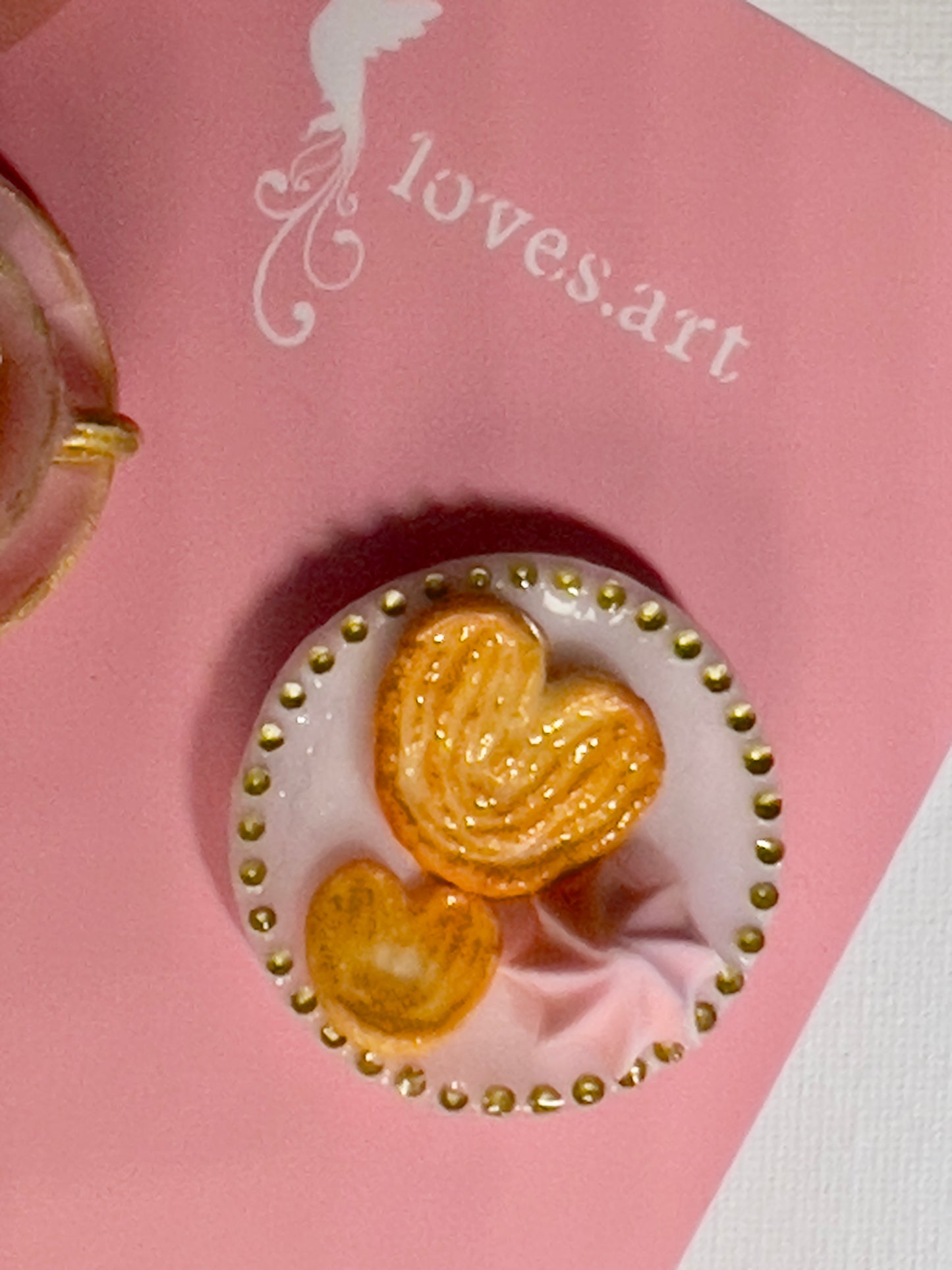 004 - Mini pink teacup with tea bag, palmiers and meringue on white saucer