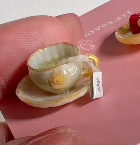 008 - Mini white teacup with tea bag, yellow saucer with waffle and raspberries
