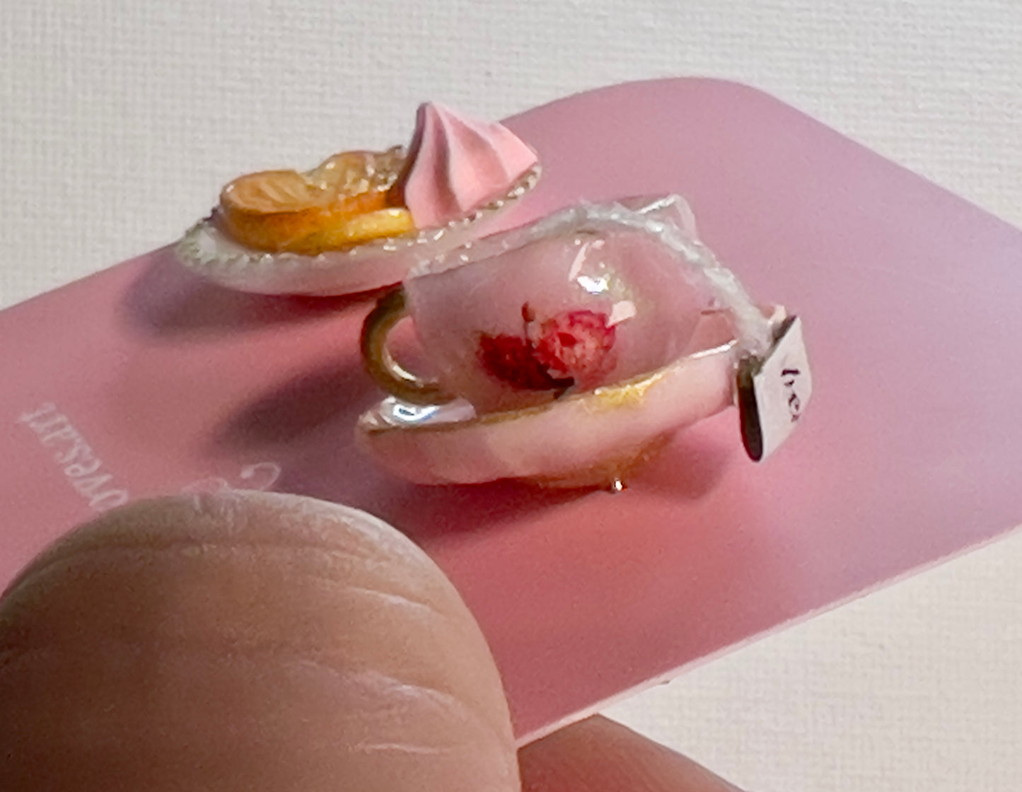 004 - Mini pink teacup with tea bag, palmiers and meringue on white saucer